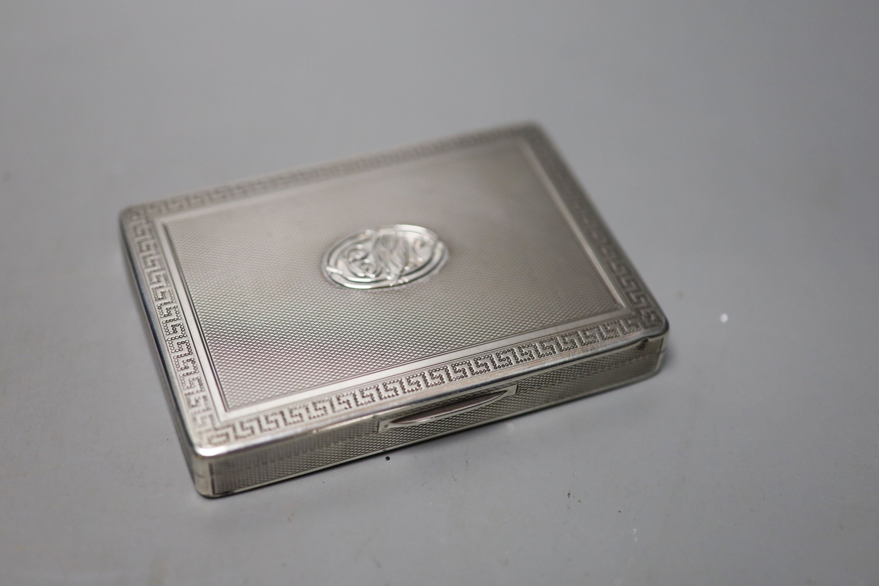 Two silver cigarette cases, largest 10.8cm, a silver vesta case, circular pill box, ashtray and dish.